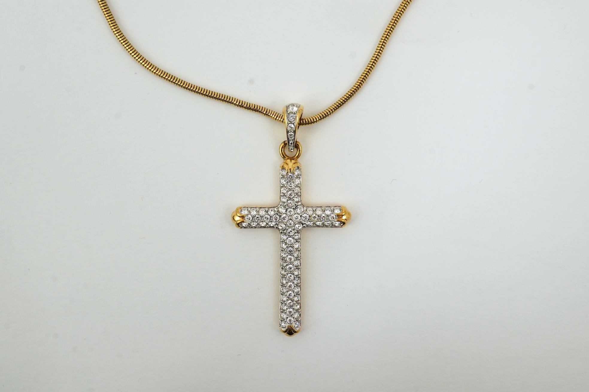 A Swarovski vintage cross necklace and ring.